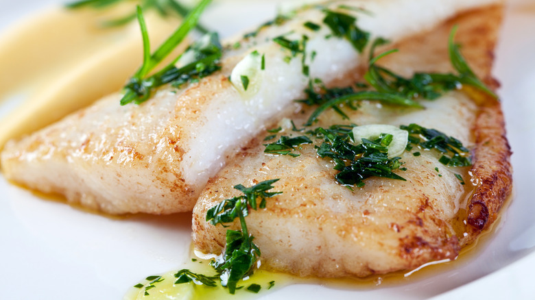 cooked filet of white fish with fresh herbs