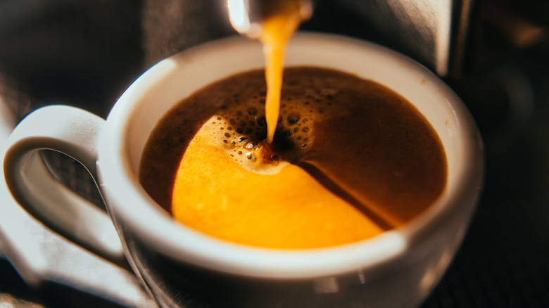 Close-up of espresso brewing into a mug