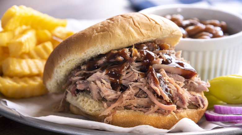 Pulled pork sandwich with fries and beans