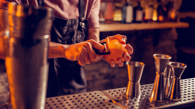 bartender peeling orange