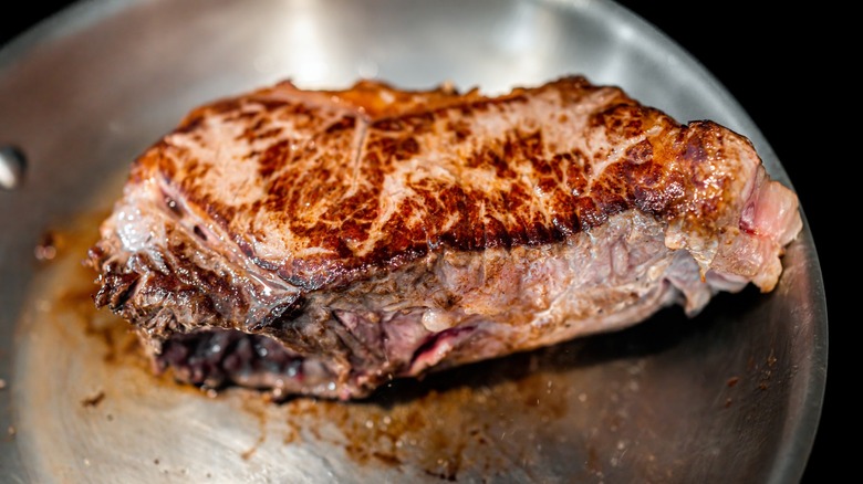 Close-up of cooked steak in a metal pan