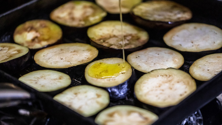 Eggplants being oiled during cooking