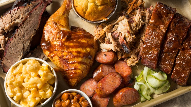 Overview of a tray of barbecued meats and side dishes