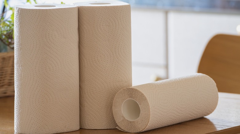 Three rolls of paper towels on a table