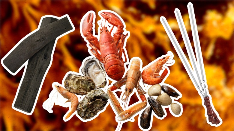 Various shellfish, charcoal, and metal skewers
