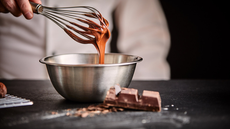 chef with whisk and metal bowl