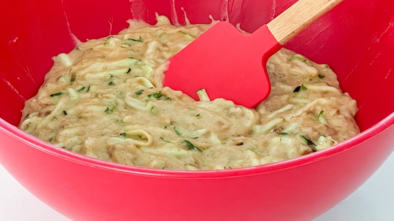 raw zucchini batter in red bowl