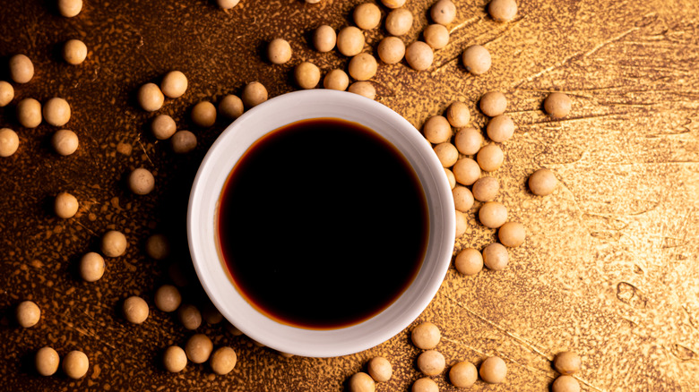 Overhead view of dish of soy sauce surrounded by chickpeas