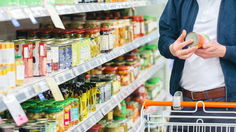 Person buying canned food