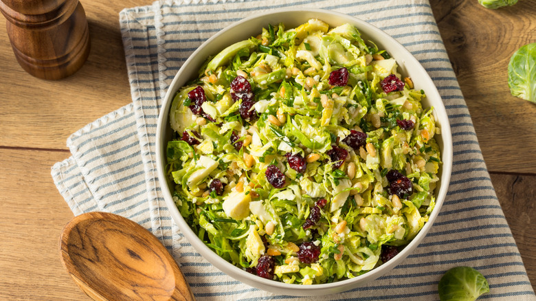 bowl of shaved brussels sprouts salad with cranberries