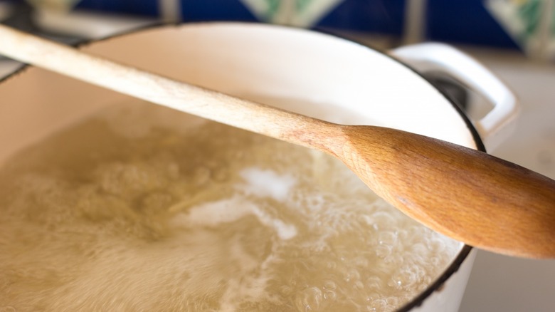 Wood spoon over boiling water