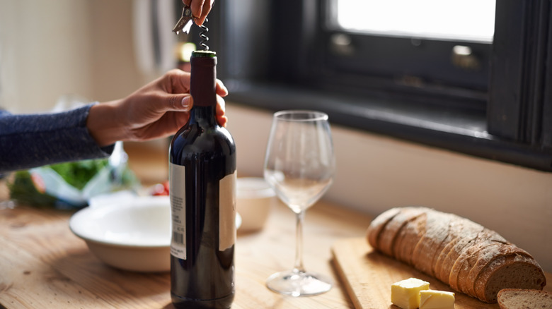 Opening wine bottle in the kitchen