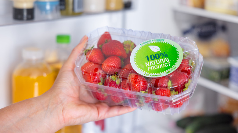 hand holding strawberry package