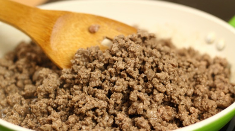 Ground beef cooking in pan