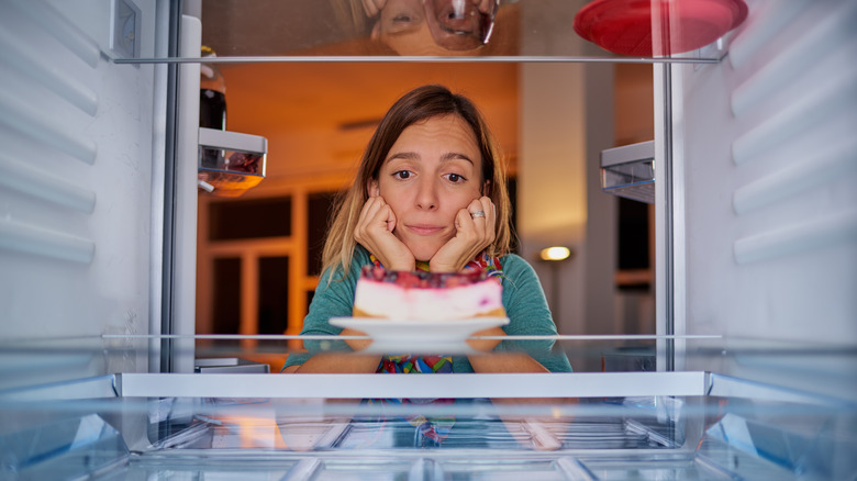 open fridge with cheesecake