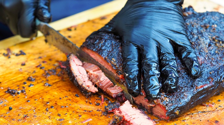 knife slicing brisket.