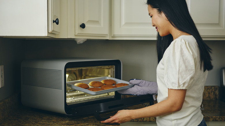 Woman making cookies in toaster oven