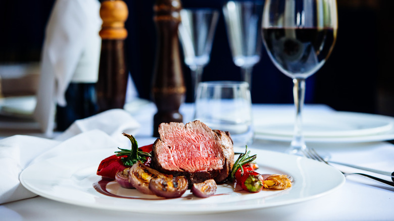 steak dinner with red wine at a restaurant