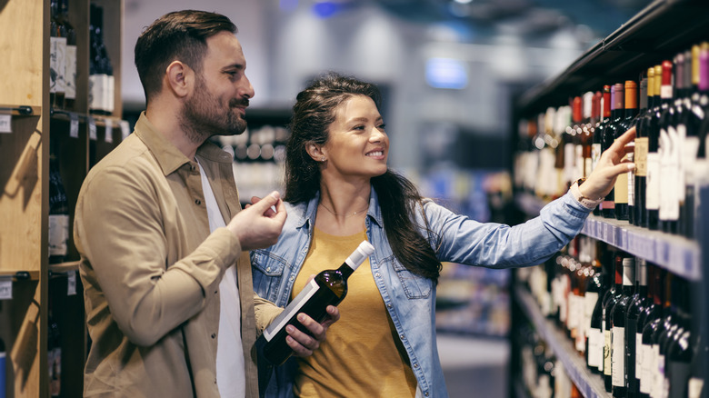 Two people shopping for wine