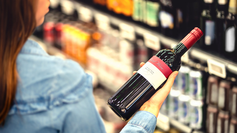 Person shopping for wine