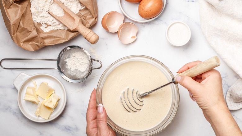 Whisking pancake batter white background