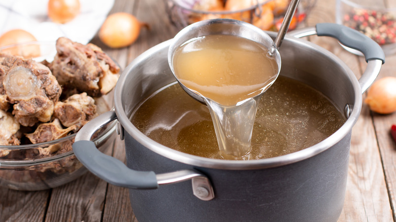 beef broth and ladle