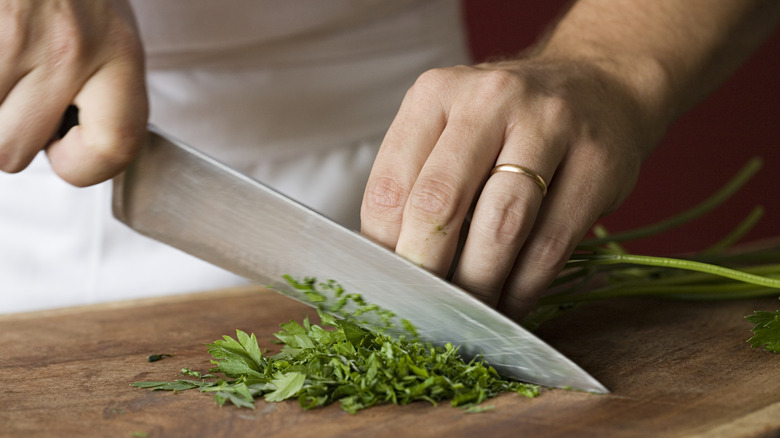 Person chopping fresh parsley