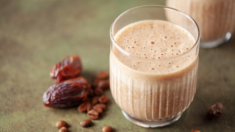 coffee date smoothie next to dried dates and coffee beans