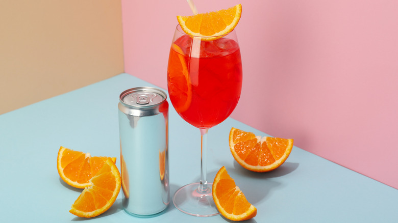 can with cocktail topped with fresh orange