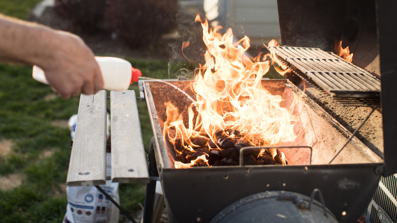 unsafe grilling practice of squirting lighter fluid onto burning coals