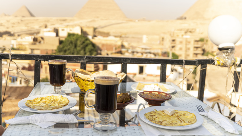 table setting with view of Egyptian pyramids 