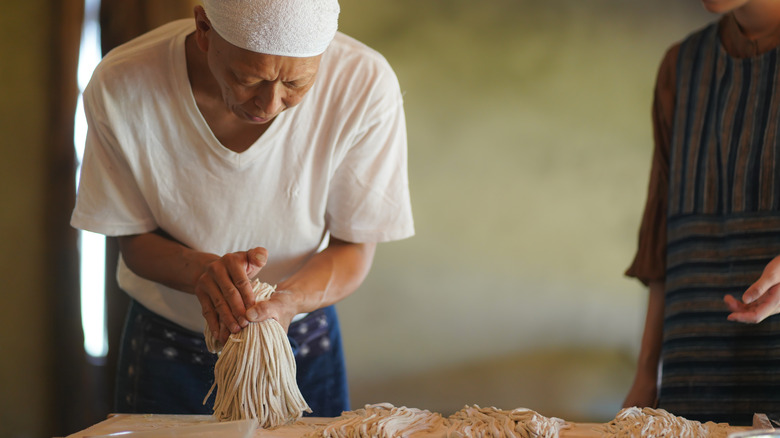 man making soba noodles