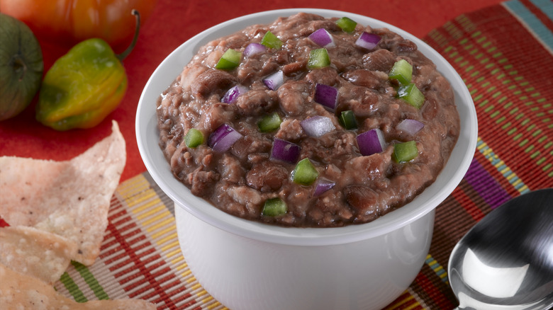 refried beans in dish with toppings