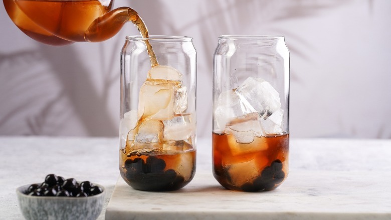 pouring iced tea into glasses