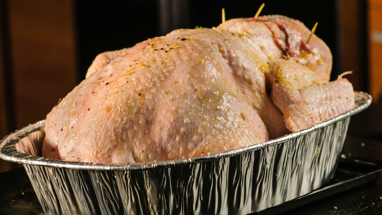 upside down raw turkey in foil  pan