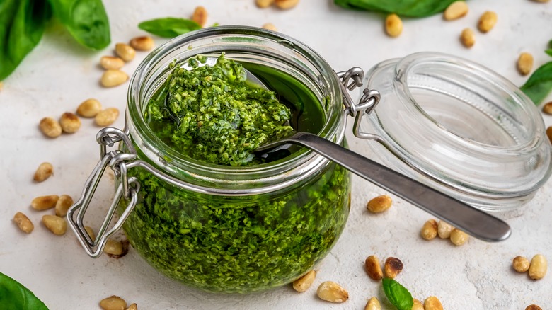 Pesto in a jar with a spoon