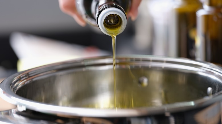 pouring cooking oil into pot