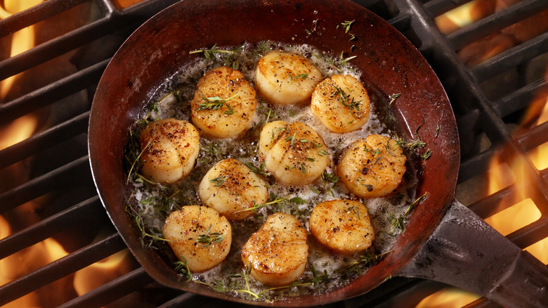 cooking scallops in pan on grill