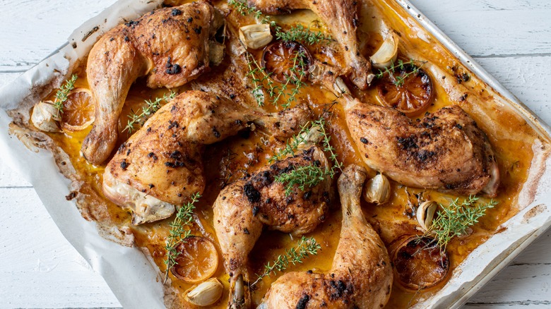 Top-down view of marinated chicken on a sheet pan