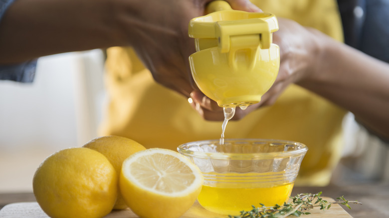 person squeezing lemon juice