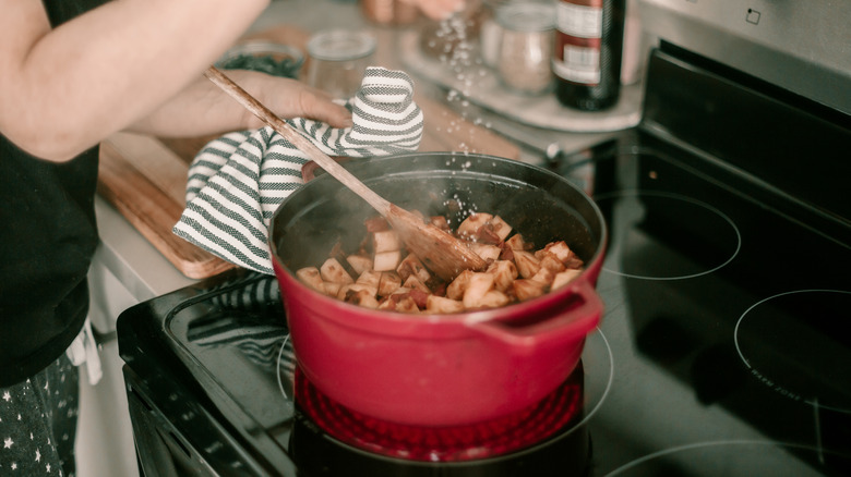 Person cooking with a Dutch oven