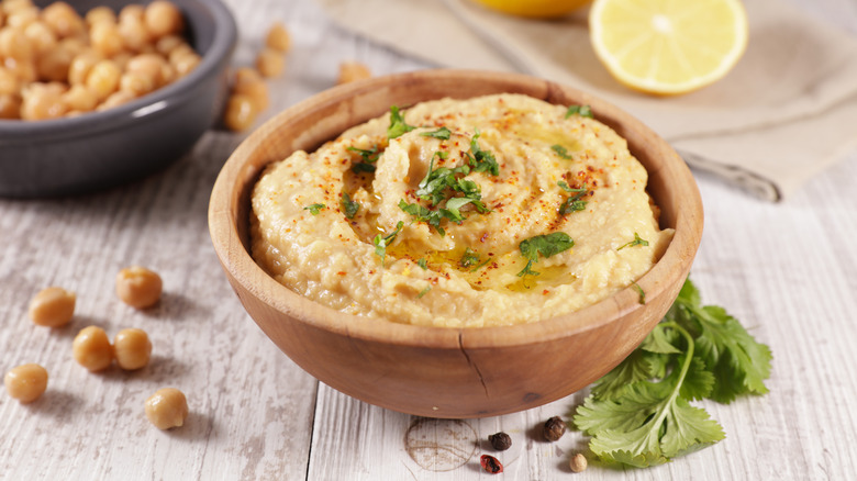 bowl of hummus garnished with parsley