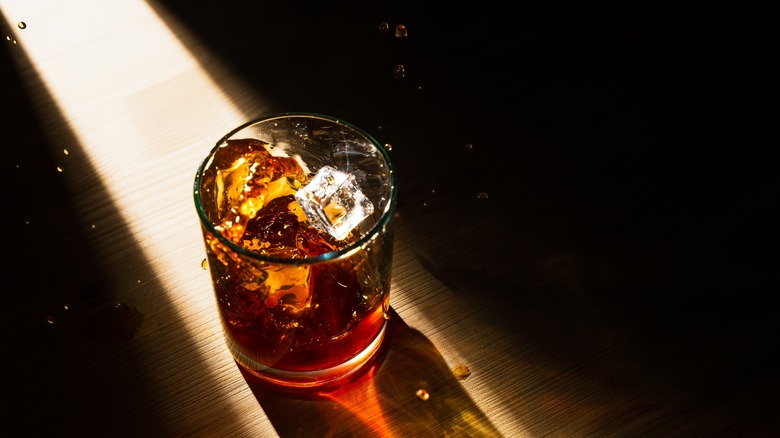 whiskey cocktail in light shaft