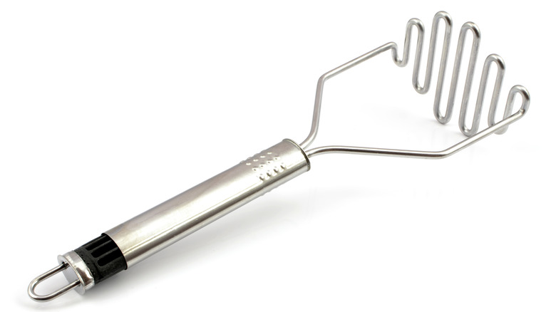 potato masher on white background