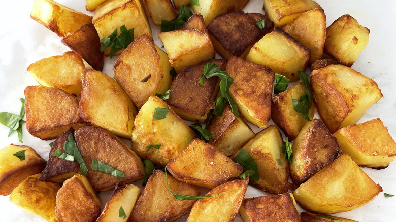 closeup of roasted potatoes with parsely garnish