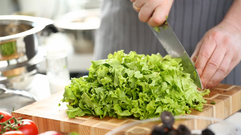 Hand chopping lettuce