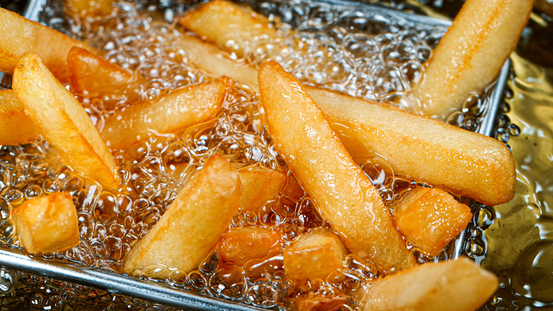 French fries being fried in oil