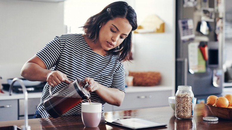 Woman using a French press