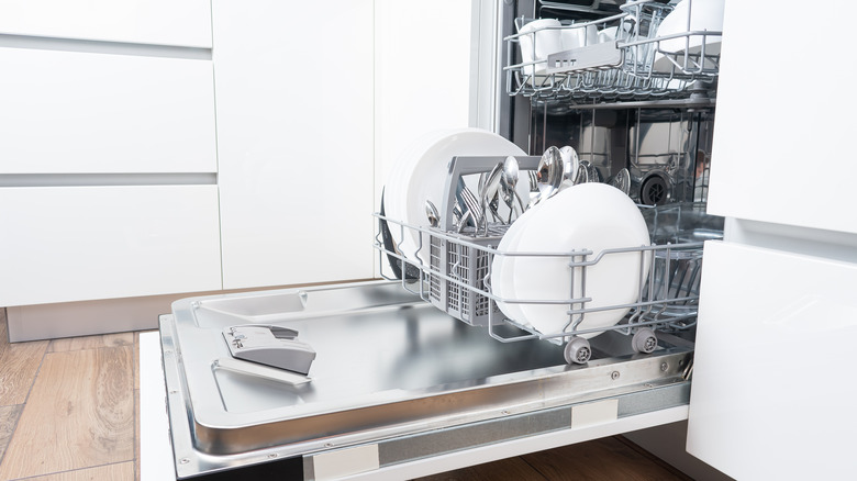 Dishwasher full of plates and silverware