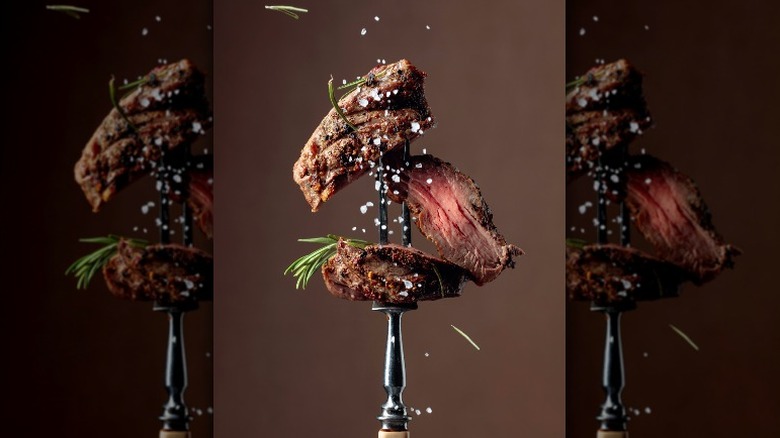 salting skewered steak 